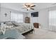 Neutral bedroom with a ceiling fan, tv, white walls, carpet, and two wooden dressers at 2738 Canvasback Trail, Myrtle Beach, SC 29588