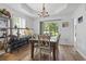 Charming dining room featuring a chandelier, large windows, and views of the backyard at 2738 Canvasback Trail, Myrtle Beach, SC 29588