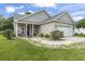 View of a single-Gathering home with a front porch, two-car garage, and well-kept lawn at 2738 Canvasback Trail, Myrtle Beach, SC 29588