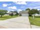 View of a single-Gathering home with a long driveway, well-maintained lawn, and surrounding trees at 2738 Canvasback Trail, Myrtle Beach, SC 29588