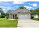 Charming single-story home with a two-car garage, well-manicured lawn, and inviting front porch at 2738 Canvasback Trail, Myrtle Beach, SC 29588