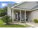 Inviting front porch with rocking chairs, decorative plants, and charming details at 2738 Canvasback Trail, Myrtle Beach, SC 29588