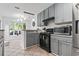 Open kitchen area with gray cabinets, breakfast bar, with view to the breakfast nook at 2738 Canvasback Trail, Myrtle Beach, SC 29588
