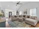Open-concept living room with large sectional sofa, hardwood floors, and inviting atmosphere at 2738 Canvasback Trail, Myrtle Beach, SC 29588