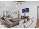 Spacious living room with a large couch, entertainment center, and views into the dining room at 2738 Canvasback Trail, Myrtle Beach, SC 29588