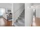 Cozy staircase with carpeted steps, white walls, and access to the living room at 2738 Canvasback Trail, Myrtle Beach, SC 29588