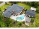 Expansive backyard featuring a pool, covered seating, and lush landscaping, as seen from an aerial perspective at 280 Morgan Ave., Little River, SC 29566