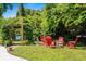 This backyard has a fire pit area, a bench swing, and lush landscaping at 280 Morgan Ave., Little River, SC 29566