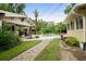 Picturesque backyard with a paver walkway, leading to a pool, gazebo, and lush landscaping at 280 Morgan Ave., Little River, SC 29566
