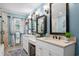 Stylish bathroom featuring double sinks, decorative mirrors, and a separate glass shower at 280 Morgan Ave., Little River, SC 29566