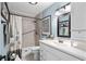 This bathroom has a walk-in shower, updated vanity, a framed mirror, and neutral paint at 280 Morgan Ave., Little River, SC 29566