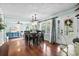 Spacious dining area featuring hardwood floors, a stylish chandelier, and a view of the entryway at 280 Morgan Ave., Little River, SC 29566