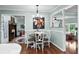 Cozy dining room with seating for four, decorative lighting, and views into the fireplace at 280 Morgan Ave., Little River, SC 29566