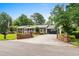 Long driveway leading to a two-car garage, framed by decorative brick walls and lush landscaping at 280 Morgan Ave., Little River, SC 29566