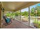 Inviting covered front porch with brick flooring, white railing, and comfortable rocking chairs at 280 Morgan Ave., Little River, SC 29566