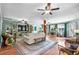 Open living space with a fireplace, large windows, hardwood floors, and comfortable seating at 280 Morgan Ave., Little River, SC 29566