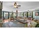 Spacious living room with ceiling fans, natural light, comfortable seating, and beautiful decor at 280 Morgan Ave., Little River, SC 29566