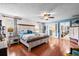 Large bedroom with hardwood floors, a ceiling fan, and an ensuite bathroom with double doors at 280 Morgan Ave., Little River, SC 29566