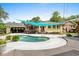 Backyard pool with pergola and bar seating, bright blue sunshade and lush landscaping at 280 Morgan Ave., Little River, SC 29566
