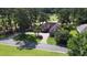 Stunning aerial view of the home with a circular driveway, well-manicured landscaping, and mature trees at 280 Oatland Lake Rd., Pawleys Island, SC 29585