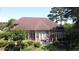 Spacious backyard with deck, patio, and lush green landscaping, great for outdoor living at 280 Oatland Lake Rd., Pawleys Island, SC 29585
