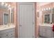Well-lit bathroom showcases double sinks, white cabinets, and wallpaper at 280 Oatland Lake Rd., Pawleys Island, SC 29585