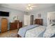 Bedroom featuring a ceiling fan, wood floors, and an ensuite bathroom at 280 Oatland Lake Rd., Pawleys Island, SC 29585