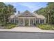 Elegant clubhouse exterior with classic columns, landscaping, and ample parking at 280 Oatland Lake Rd., Pawleys Island, SC 29585