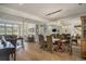 Open-concept dining room with wood floors, modern lighting, and large windows at 280 Oatland Lake Rd., Pawleys Island, SC 29585