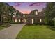 Brick home with paver driveway, lush lawn, and a colorful sunset backdrop at 280 Oatland Lake Rd., Pawleys Island, SC 29585
