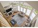 Open-concept living room with hardwood floors, a fireplace, lots of windows, and a ceiling fan at 280 Oatland Lake Rd., Pawleys Island, SC 29585