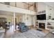 Open-concept living room with fireplace, high ceilings, and a loft view at 280 Oatland Lake Rd., Pawleys Island, SC 29585