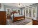 Comfortable main bedroom with wood floors, a ceiling fan, and French doors to the outside at 280 Oatland Lake Rd., Pawleys Island, SC 29585