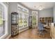 Bright home office featuring hardwood floors, lots of windows, built-in shelving, and a ceiling fan at 280 Oatland Lake Rd., Pawleys Island, SC 29585