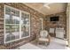 Covered brick patio is the perfect place to relax and enjoy the outdoors with ceiling fan and barbeque at 280 Oatland Lake Rd., Pawleys Island, SC 29585