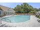 Inviting community pool surrounded by lounge chairs, lush landscaping, and a charming fence at 280 Oatland Lake Rd., Pawleys Island, SC 29585