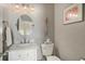 Stylish powder room features a decorative mirror and attractive decor at 280 Oatland Lake Rd., Pawleys Island, SC 29585
