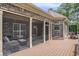 Relaxing screened porch with brick exterior and outdoor furniture, perfect for enjoying the outdoors at 280 Oatland Lake Rd., Pawleys Island, SC 29585
