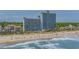 Aerial shot of a resort with beautiful beach access, umbrellas, and chairs on the sand at 3000 N Ocean Blvd. # 230, Myrtle Beach, SC 29577