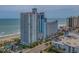 View of a multi-story resort with a pool, balconies, and proximity to the ocean and beach at 3000 N Ocean Blvd. # 230, Myrtle Beach, SC 29577