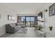 Tastefully furnished living room with decor, television, balcony access, and a small dining set, creating a welcoming space at 3000 N Ocean Blvd. # 230, Myrtle Beach, SC 29577