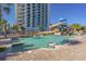 Resort-style pool features a twisting waterslide, brick trim, and inviting clear blue water, set beneath a luxury high-rise at 3000 N Ocean Blvd. # 230, Myrtle Beach, SC 29577