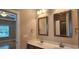 Bathroom featuring double sinks, two framed mirrors and entry to bedroom and shower at 309 Outboard Dr., Murrells Inlet, SC 29576