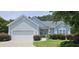 Charming single-story home with a two-car garage, manicured lawn, and inviting curb appeal at 309 Outboard Dr., Murrells Inlet, SC 29576