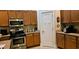Well-lit kitchen with wooden cabinets, granite countertops, and modern appliances at 309 Outboard Dr., Murrells Inlet, SC 29576