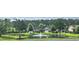 Scenic view of neighborhood pond with fountain, lush landscaping, and well-maintained homes at 309 Outboard Dr., Murrells Inlet, SC 29576