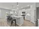 Bright kitchen features modern white cabinets, stainless appliances, a center island and an adjacent dining area at 315 River Edge Dr., Myrtle Beach, SC 29588