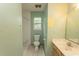 Well-lit bathroom featuring a single sink vanity, toilet, and shower with a neutral color scheme at 318 Muirfield Rd., Myrtle Beach, SC 29588