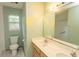 Bathroom featuring a double sink vanity and a large mirror over a toilet and shower at 318 Muirfield Rd., Myrtle Beach, SC 29588