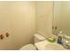Modest bathroom featuring a toilet, sink, mirror, and a wall mounted shelf at 318 Muirfield Rd., Myrtle Beach, SC 29588